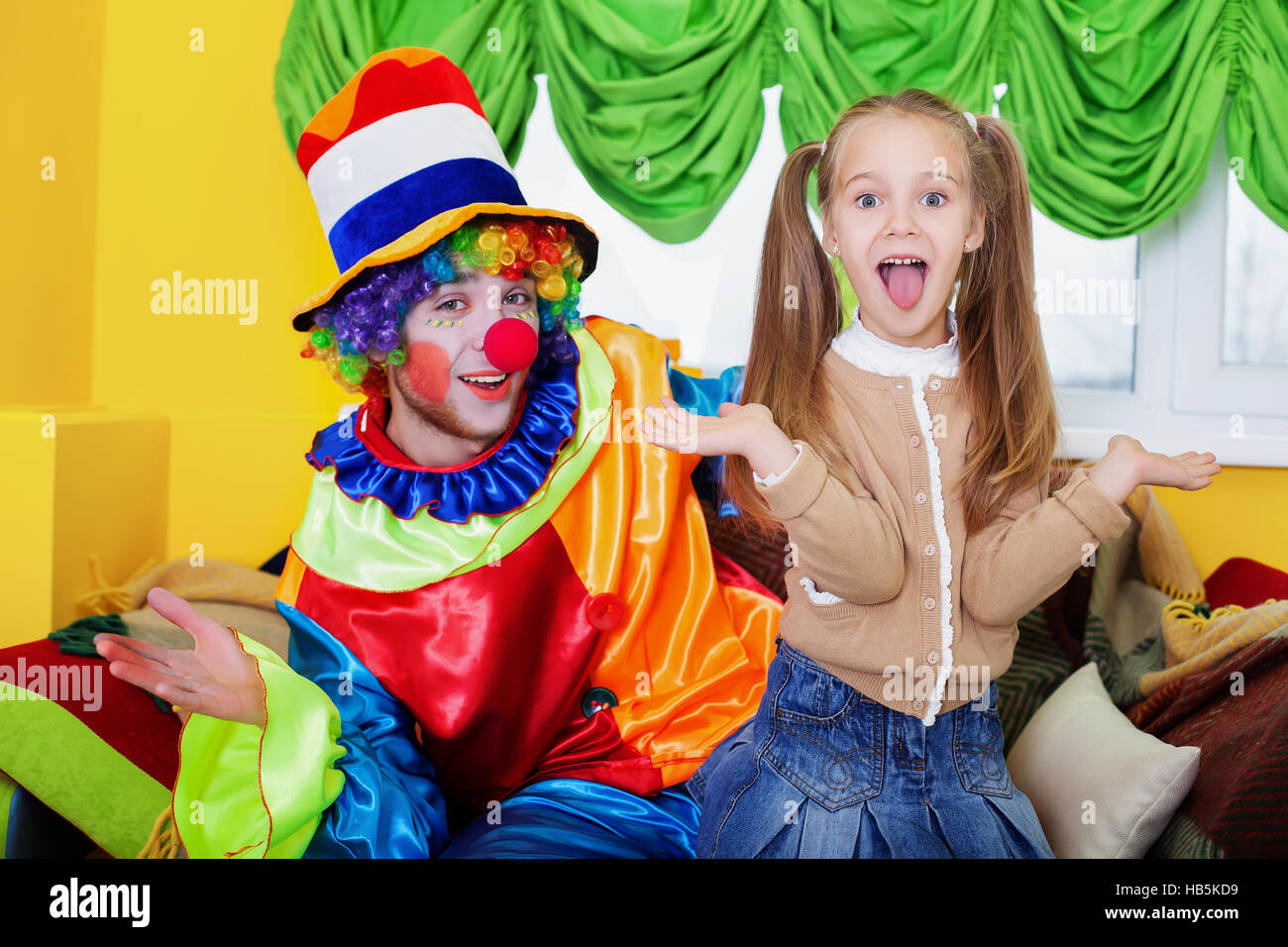 Child girl and clown playing on birthday party Stock Photo Alamy
