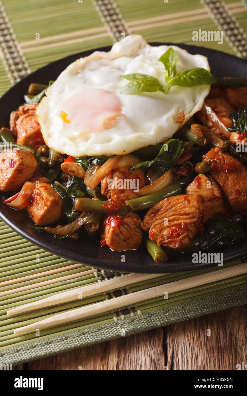 Thai cuisine StirFry Chicken with basil, green beans and a fried egg