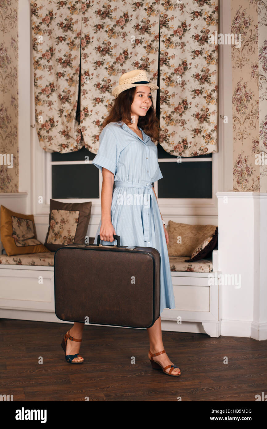 Female traveler standing in the room with luggage Stock Photo - Alamy