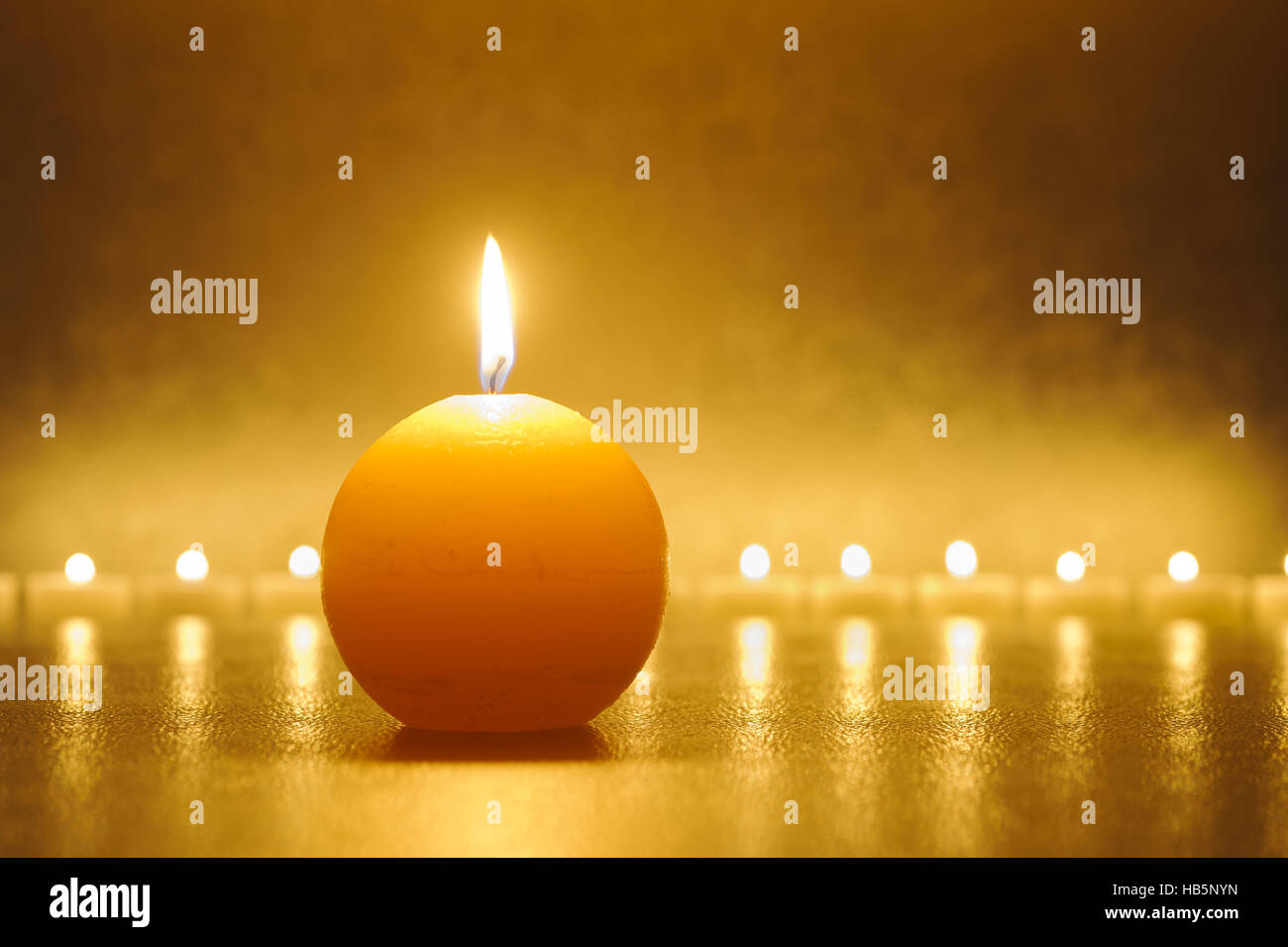 burning candle light in warm color Stock Photo