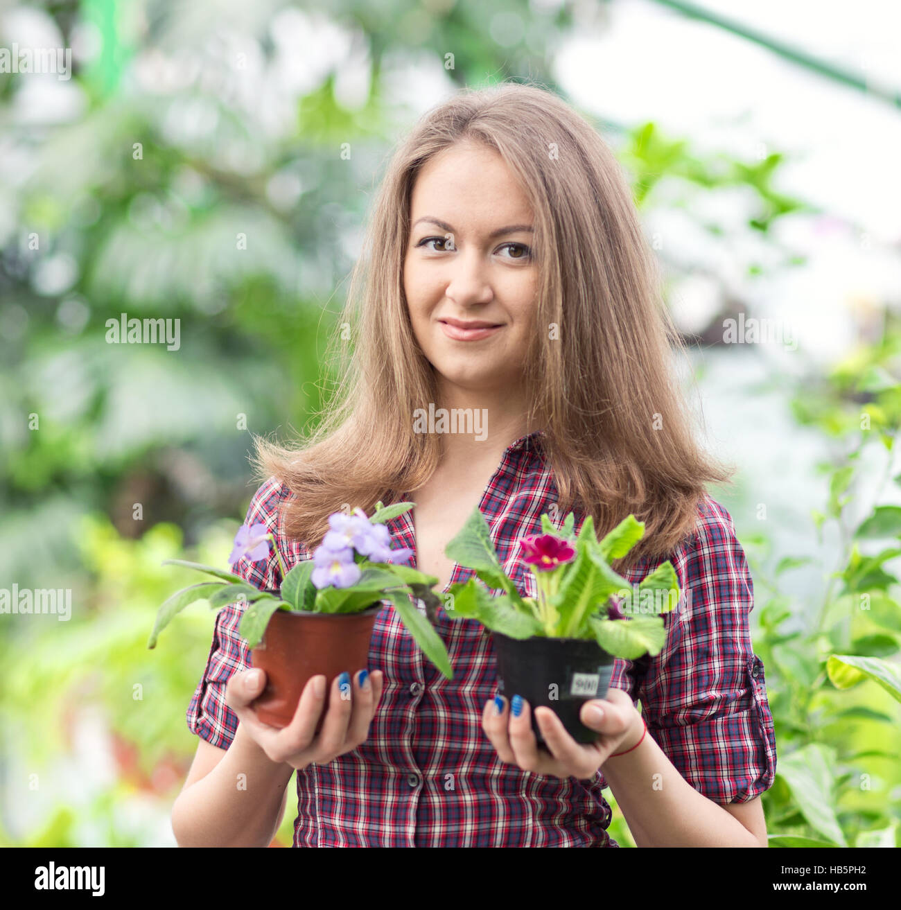 smiling woman in greenhouse Stock Photo - Alamy