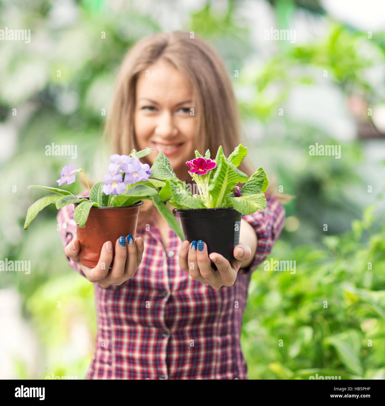 smiling woman in greenhouse Stock Photo - Alamy