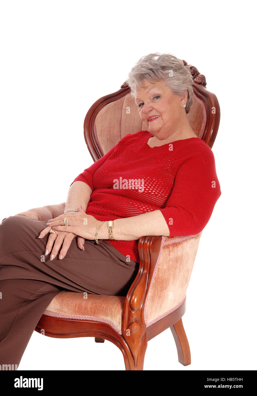 Relaxed senior woman sitting in armchair Stock Photo - Alamy