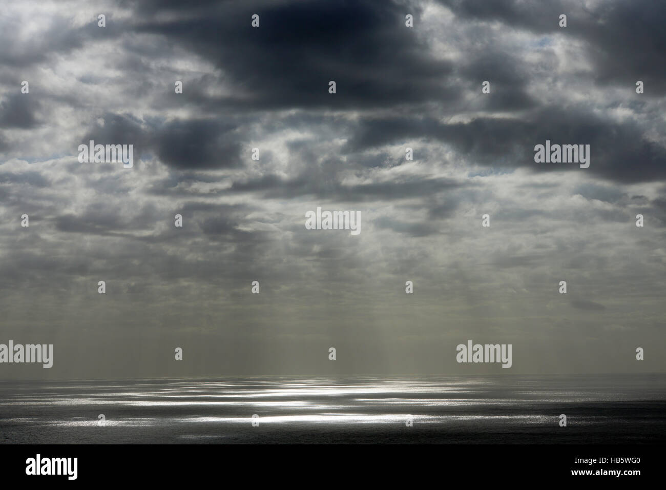 clouds and sunbeams over the sea Stock Photo - Alamy