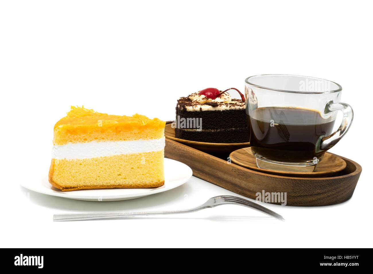 Chiffon cake in a white plate and a cup of coffee with chocolate cake in a wooden tray on white background Stock Photo