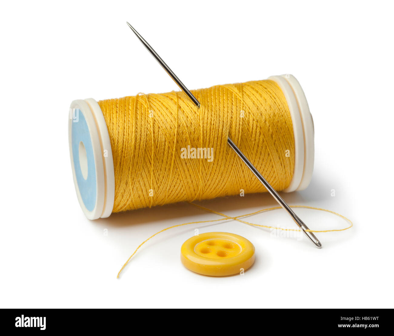 Spools of thread and buttons with needle Stock Photo - Alamy