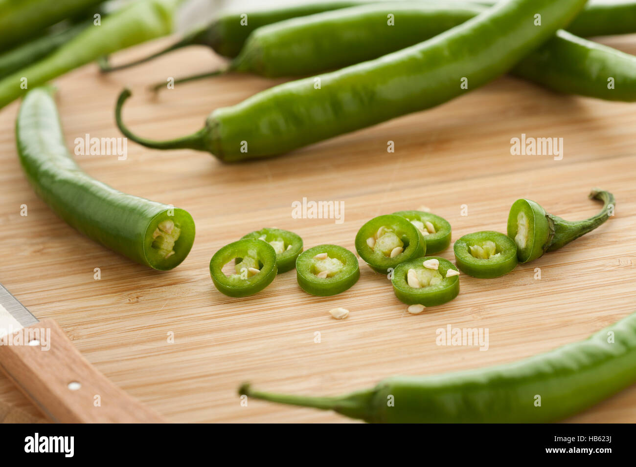 Green hot chili peppers, slices and seeds Stock Photo