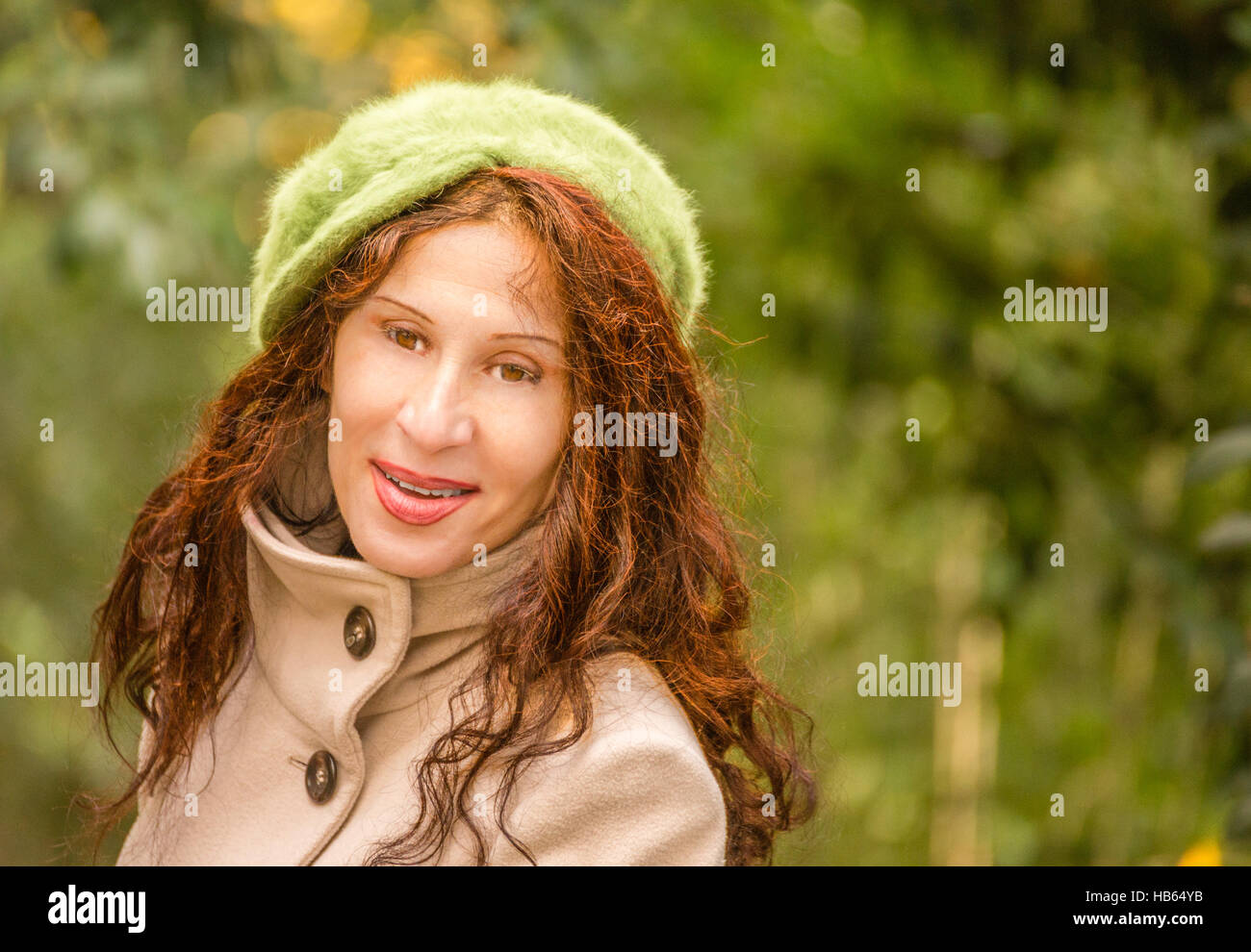 old menopausal woman with green hat in park in autumn Stock Photo Alamy