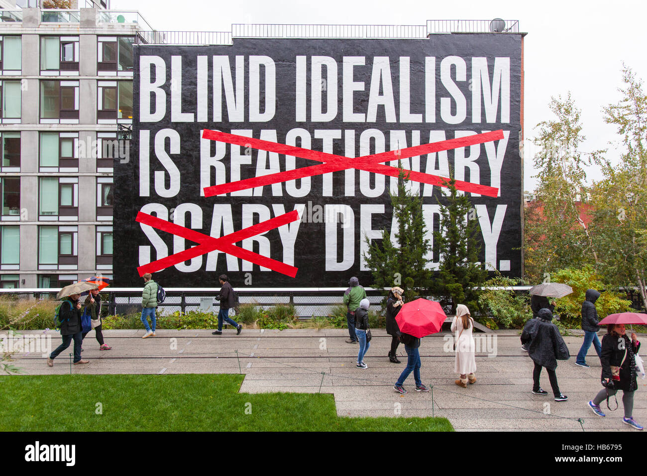 Blind idealism is Deadly by Barbara Kruger a large mural painted on the side of a building in High Line Park, New York City, America. Stock Photo