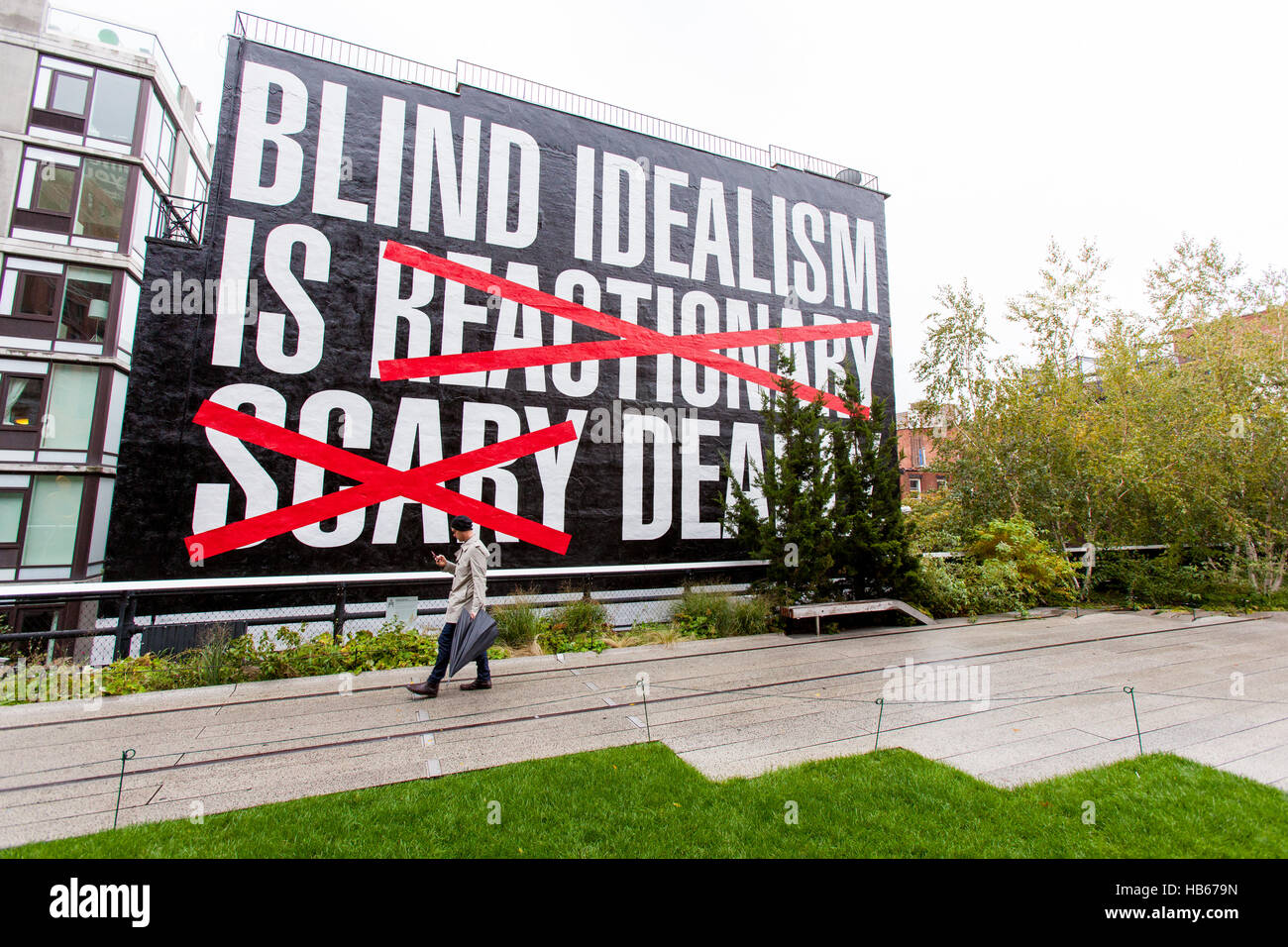 Blind idealism is Deadly by Barbara Kruger a large mural painted on the side of a building in High Line Park, New York City, America. Stock Photo