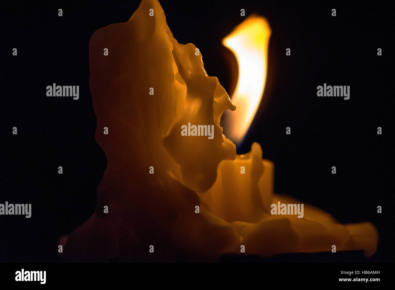 burning candle with wax Stock Photo