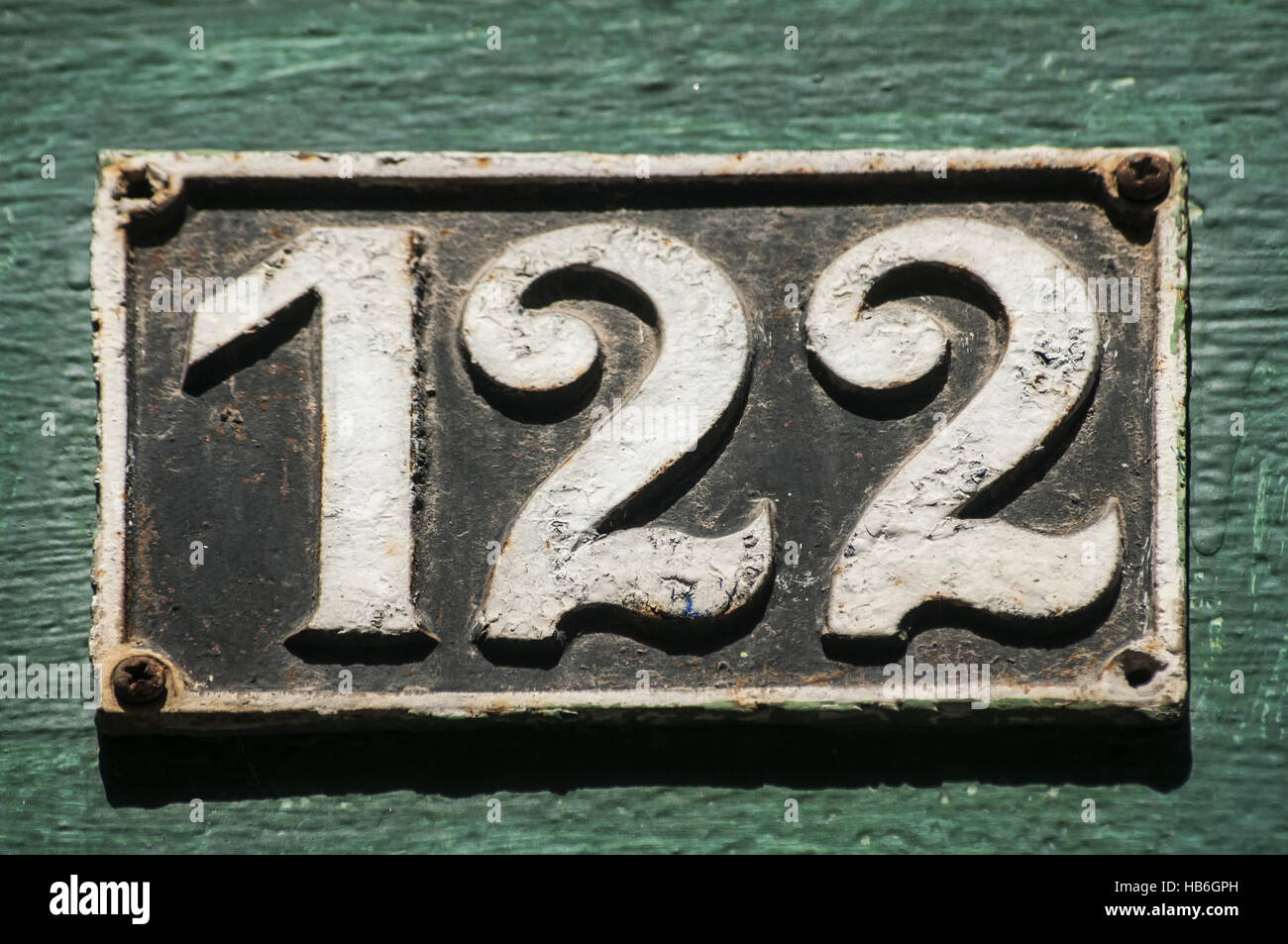 Old cast iron plate number 122 Stock Photo - Alamy