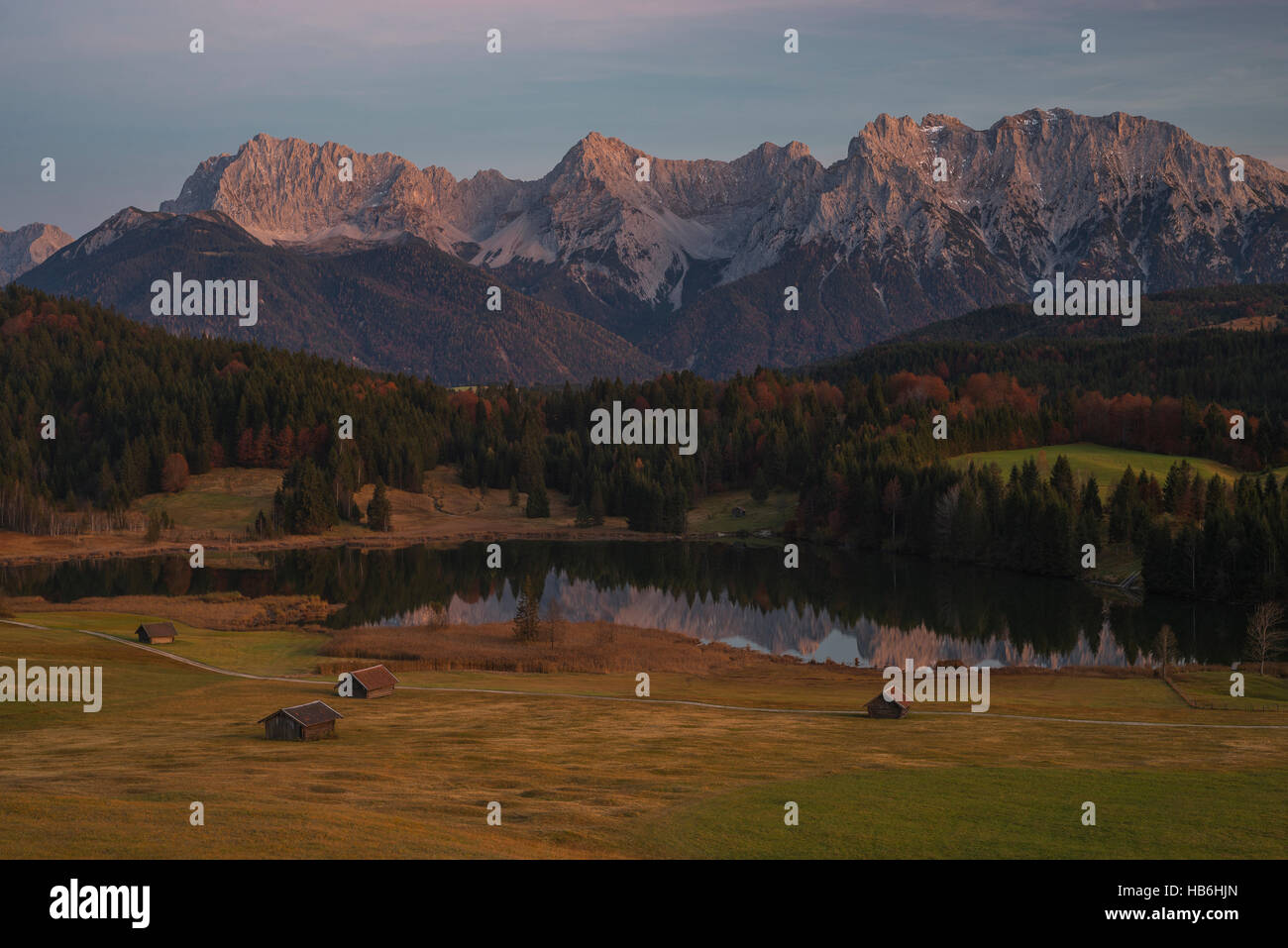 Alpenglow afterglow of the Karwendel mountain range at tranquil Lake Geroldsee after sunset in autumn, Upper Bavaria, Germany Stock Photo