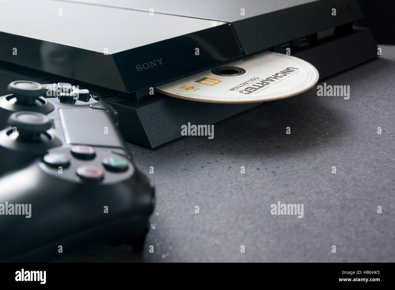 WROCLAW, POLAND -  NOVEMBER 30th, 2016: Playstation 4 on desk. The PlayStation 4 is a home video game console developed by Sony Computer Entertainment Stock Photo