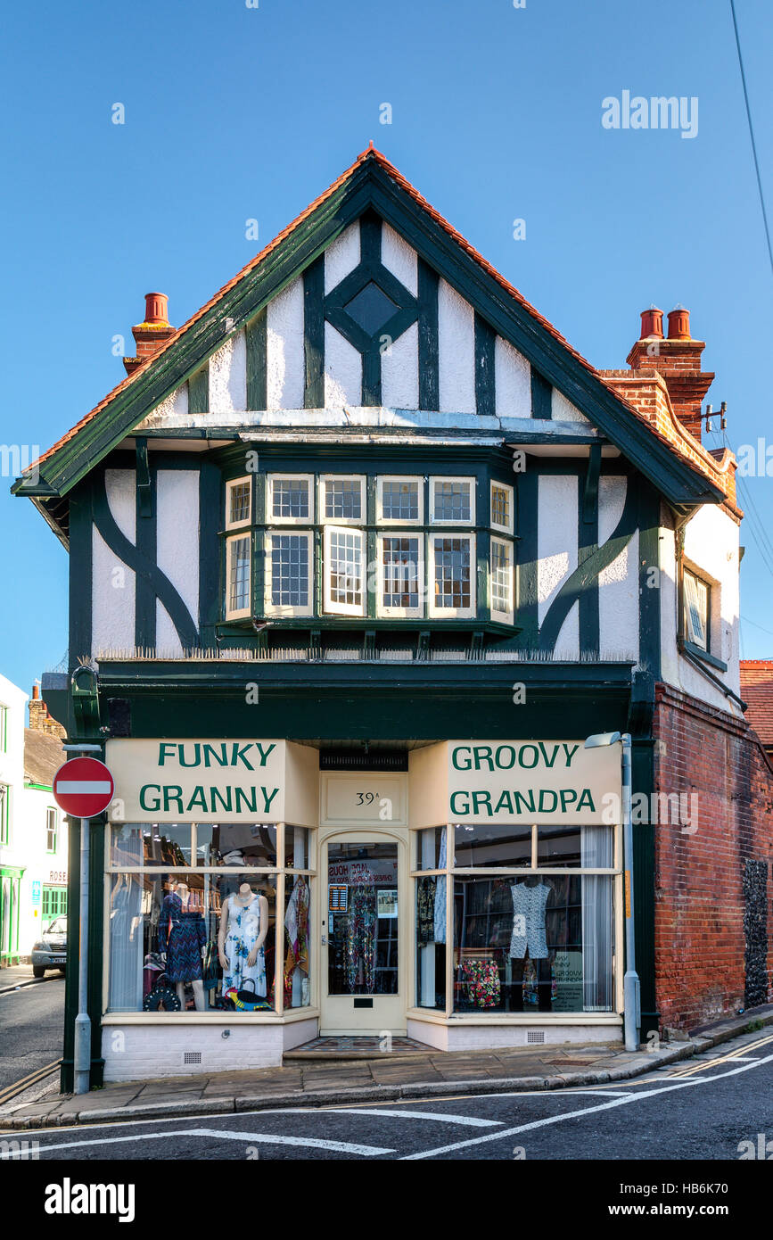 England, Sandwich. Medieval Elizabethan double fronted white plaster and black timber building on road junction, now clothing shop for seniors. Stock Photo