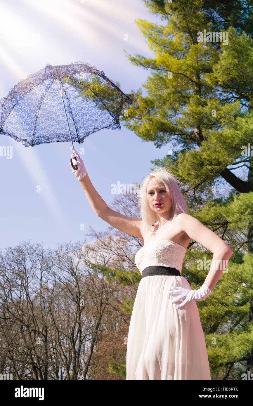 Woman holds up a lace umbrella Stock Photo