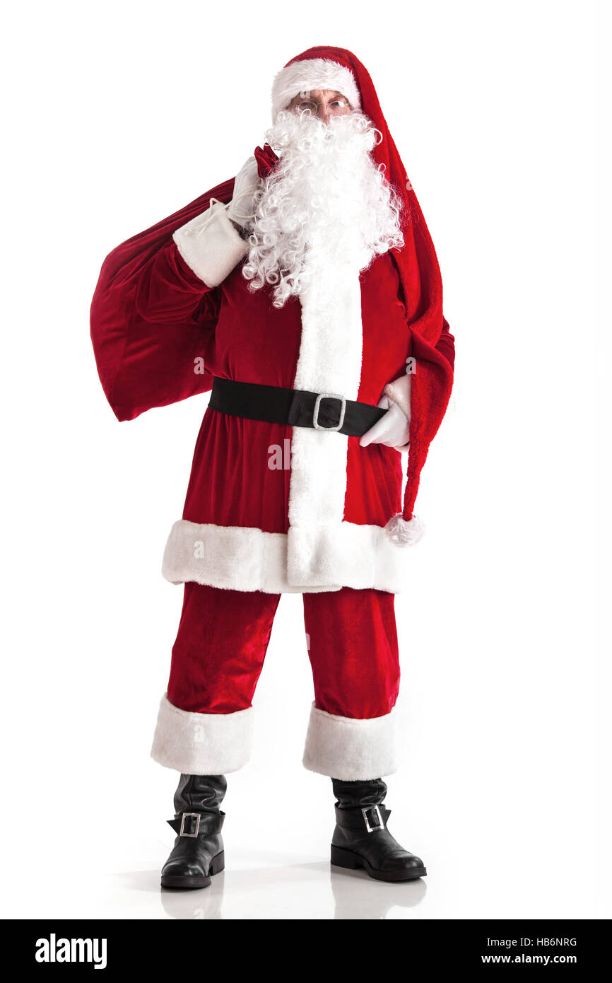 Santa Claus carrying big bag of gifts isolated on white background ...