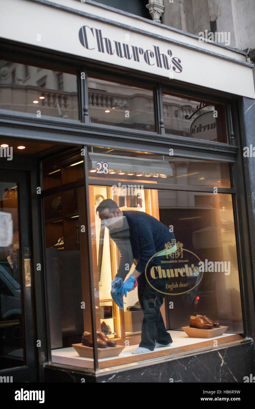 Churchs shoe shop London Window cleaner  cleaning interior Stock Photo