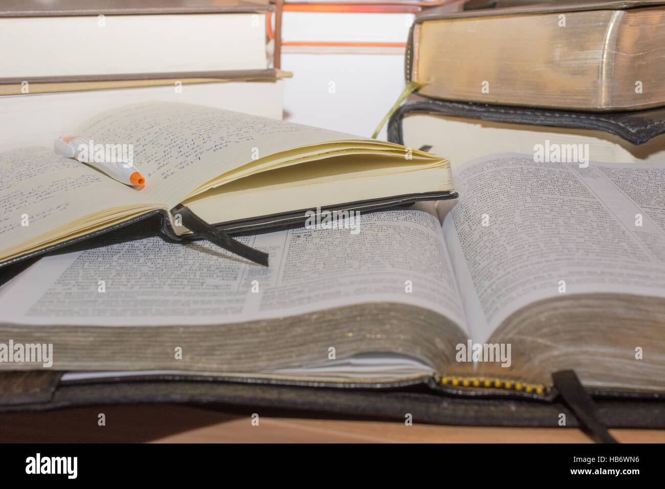 Bible study with books and journal at a desk. Stock Photo
