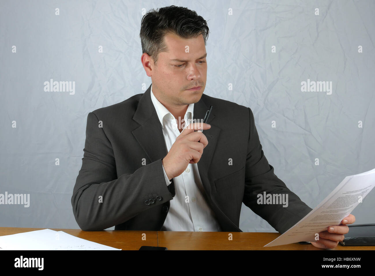 Young business man writing on a paper Stock Photo - Alamy