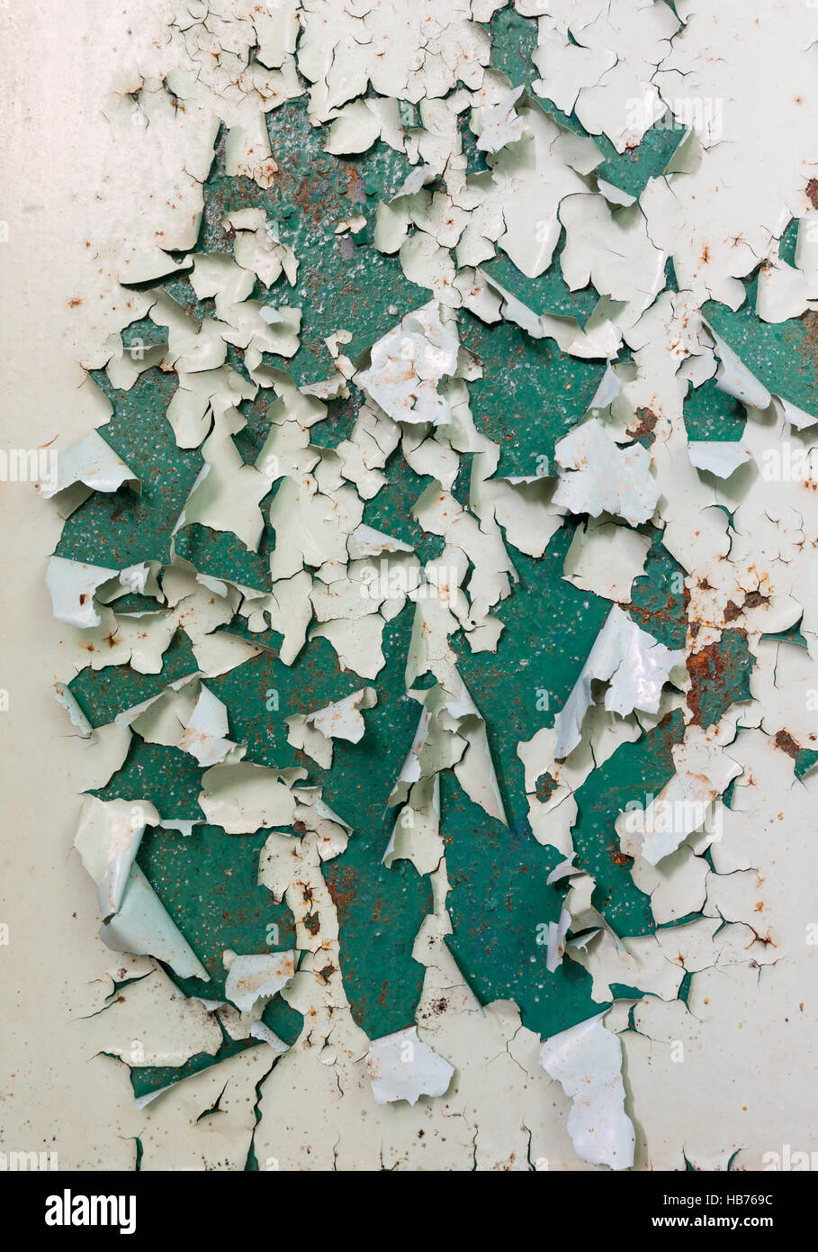 Old green paintwork on wall peeling off Stock Photo
