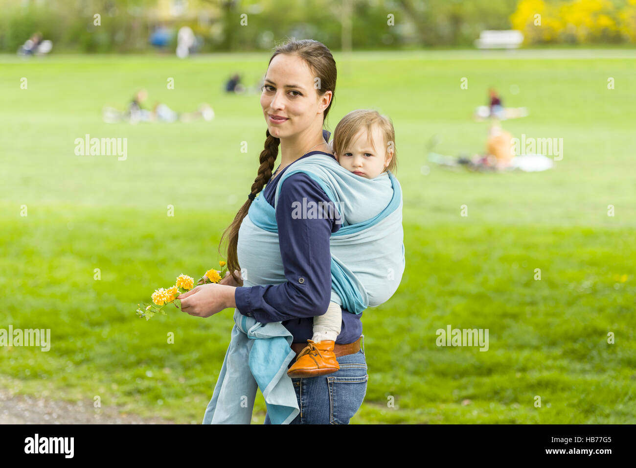 mother and child in baby sling Stock Photo