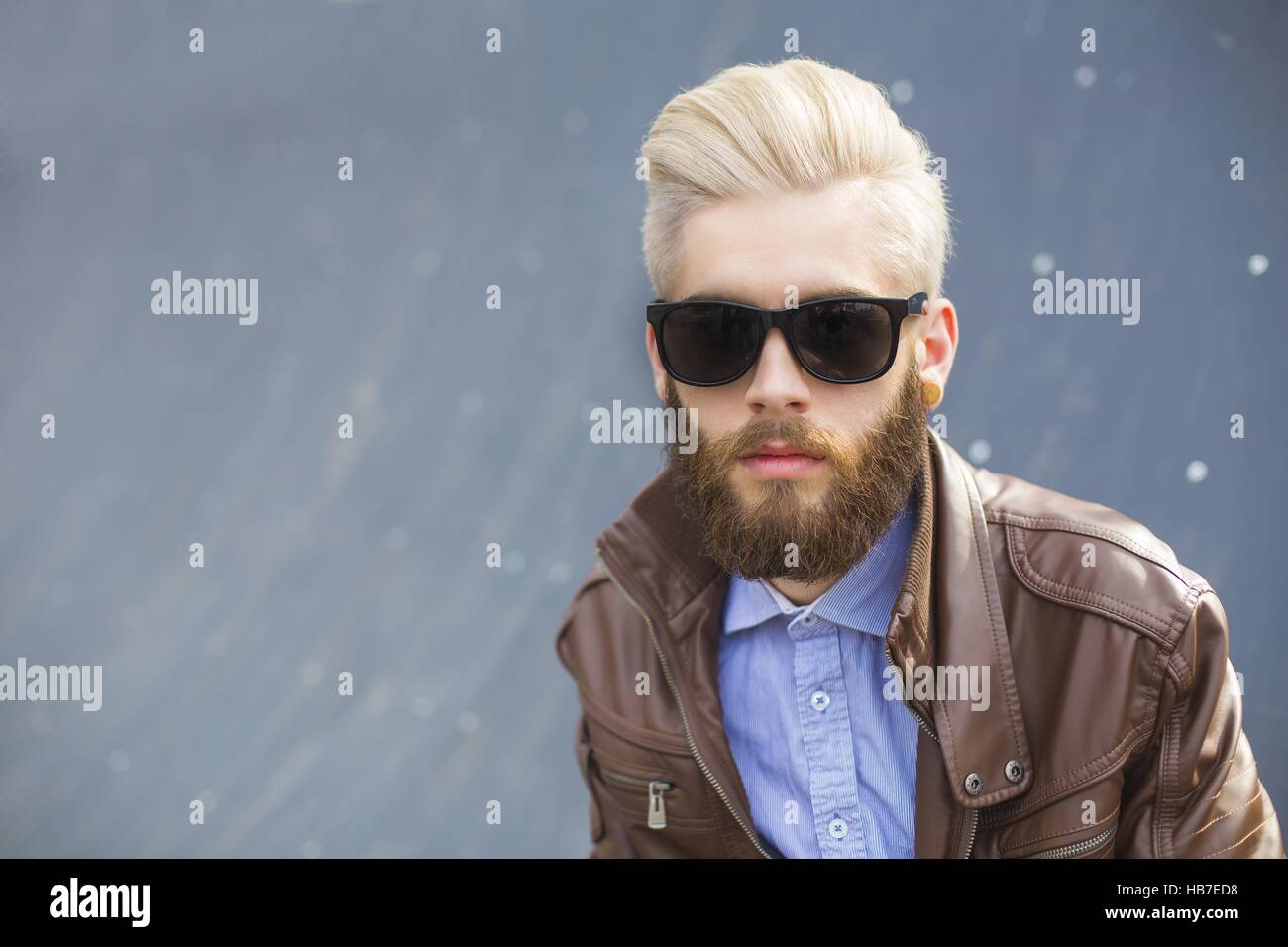 Portrait of a dyed blond hipster guy with black sunglasses Stock Photo -  Alamy