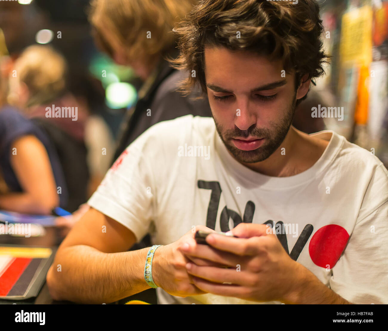 Young man surfing on the internet on his smart phone. Stock Photo