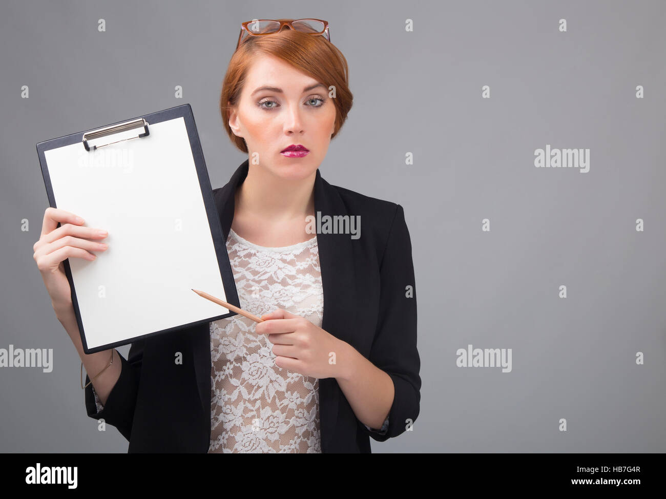 young red-haired secretary with a blank folder Stock Photo - Alamy