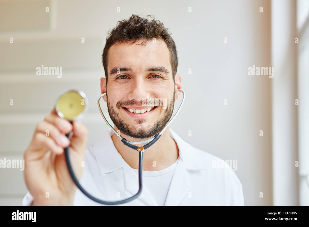 Medical specialist with stethoscope smiling Stock Photo
