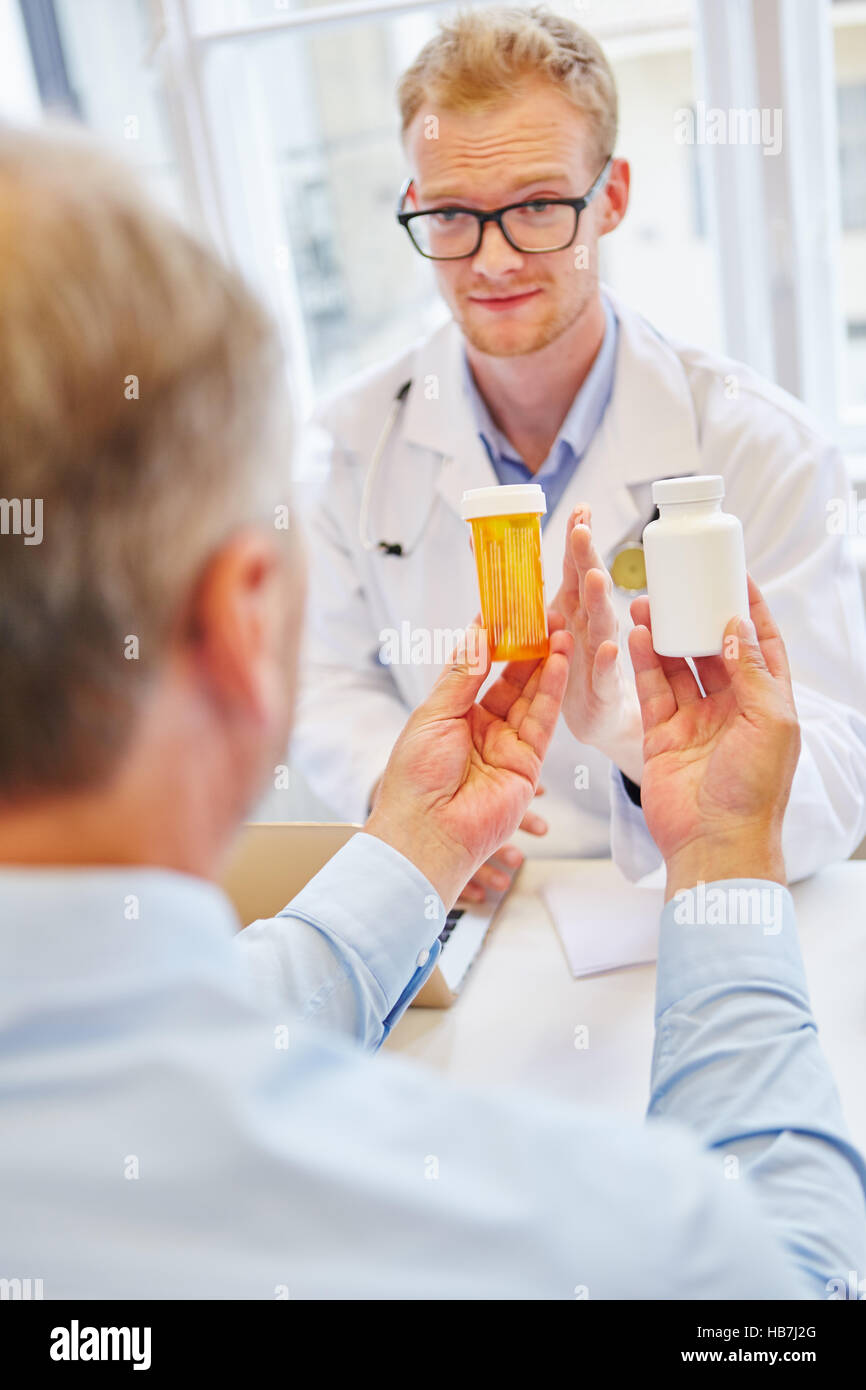 Doctor and patient with medicament talking about therapy Stock Photo