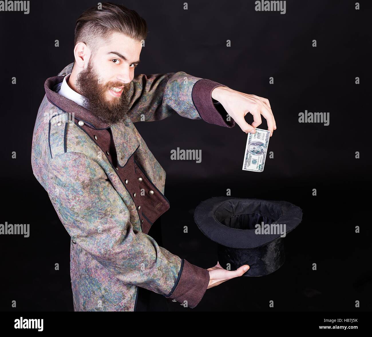 Sneaky wizard man making money with witchcraft. Stock Photo