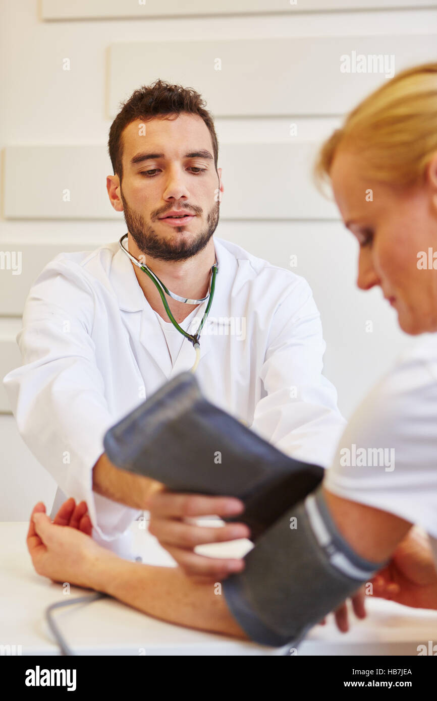 Doctor during provision examination to check hypertension Stock Photo