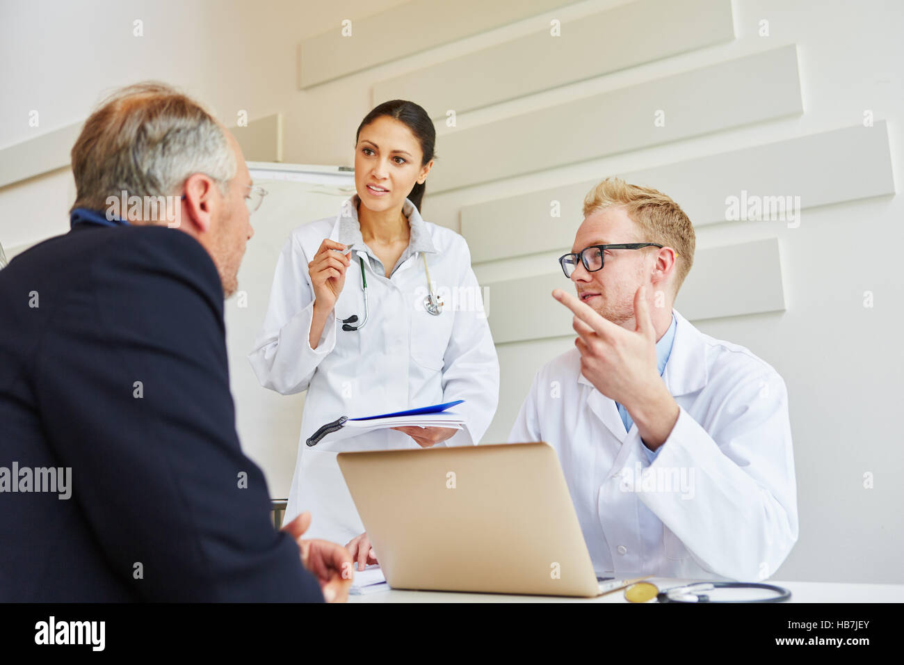 Doctors advicing patient about therapy in consultation Stock Photo