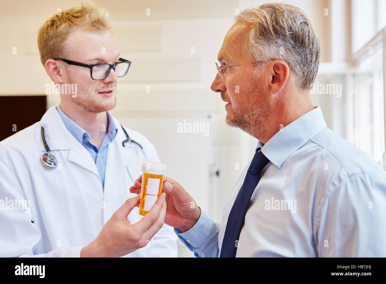 Doctor or physician gives painkiller to patient for further treatment Stock Photo