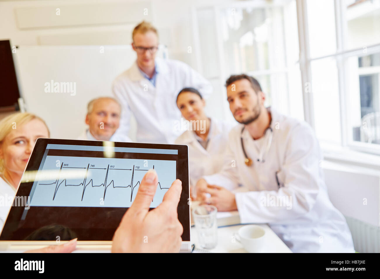 Doctors discussing ECG finding in meeting and thinking about diagnostic for patient Stock Photo