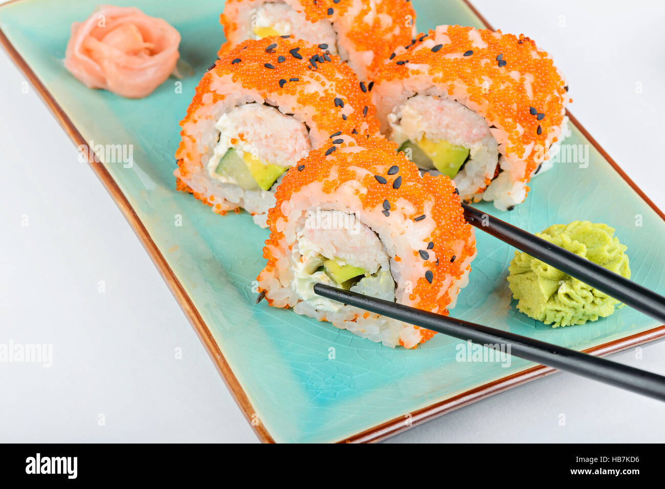 Sushi roll with black chopsticks Stock Photo