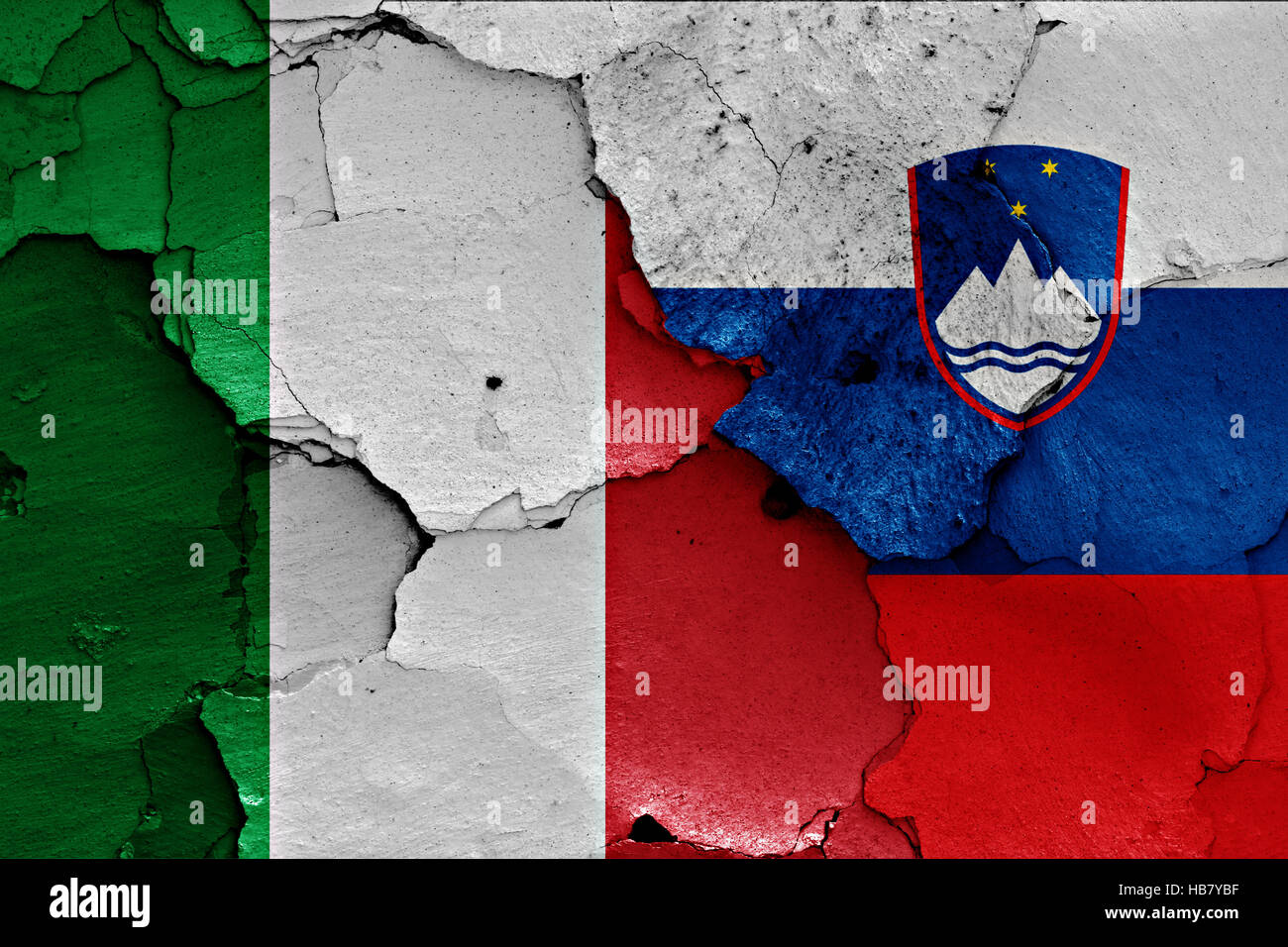 flags of Italy and Slovenia painted on cracked wall Stock Photo