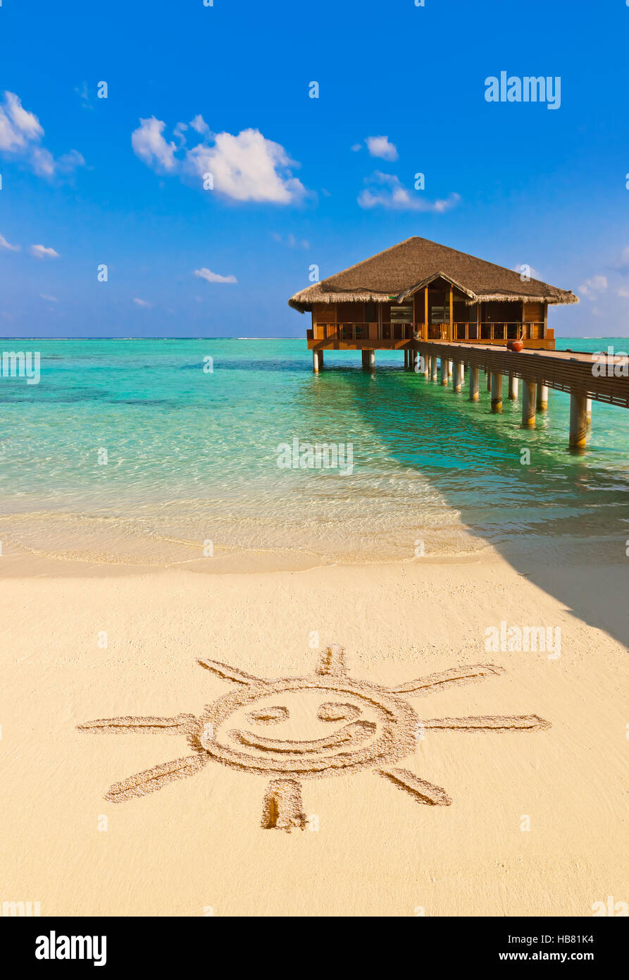 Drawing sun on beach Stock Photo