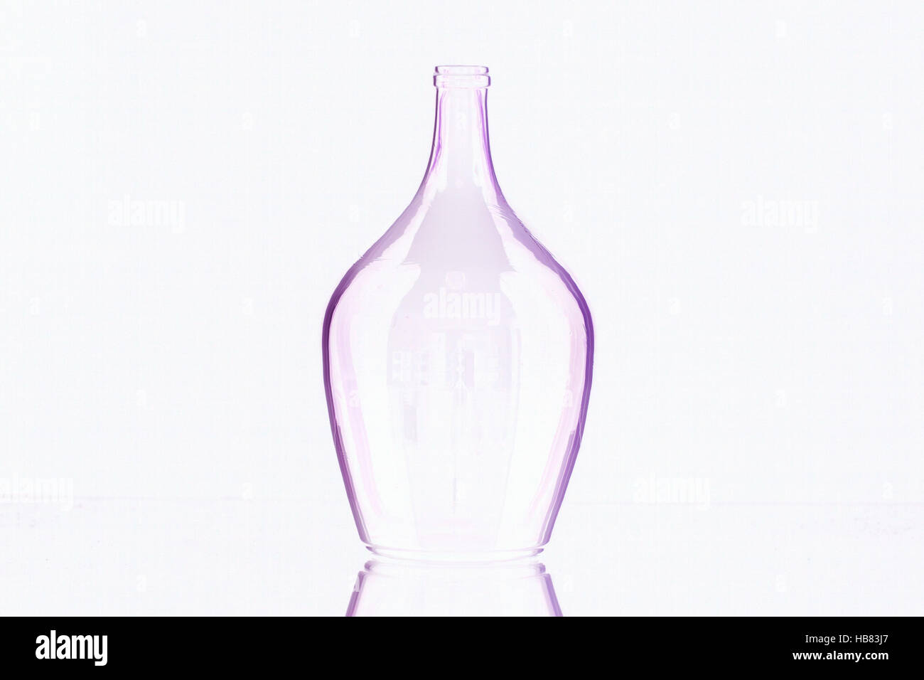 Silhouette of elegant old wine bottle on a glass desk Stock Photo