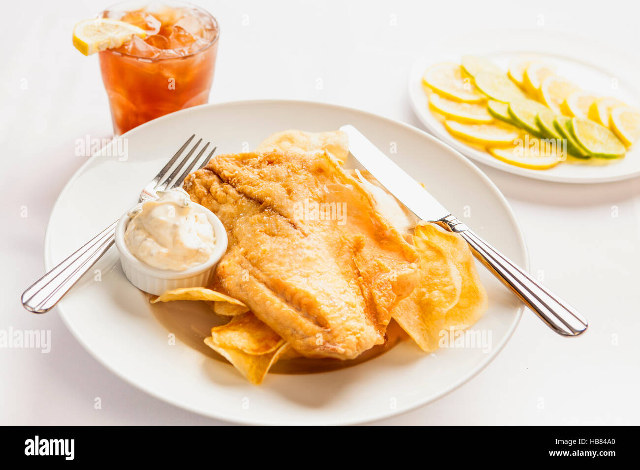 fried Pacific cod with an ice tea Stock Photo