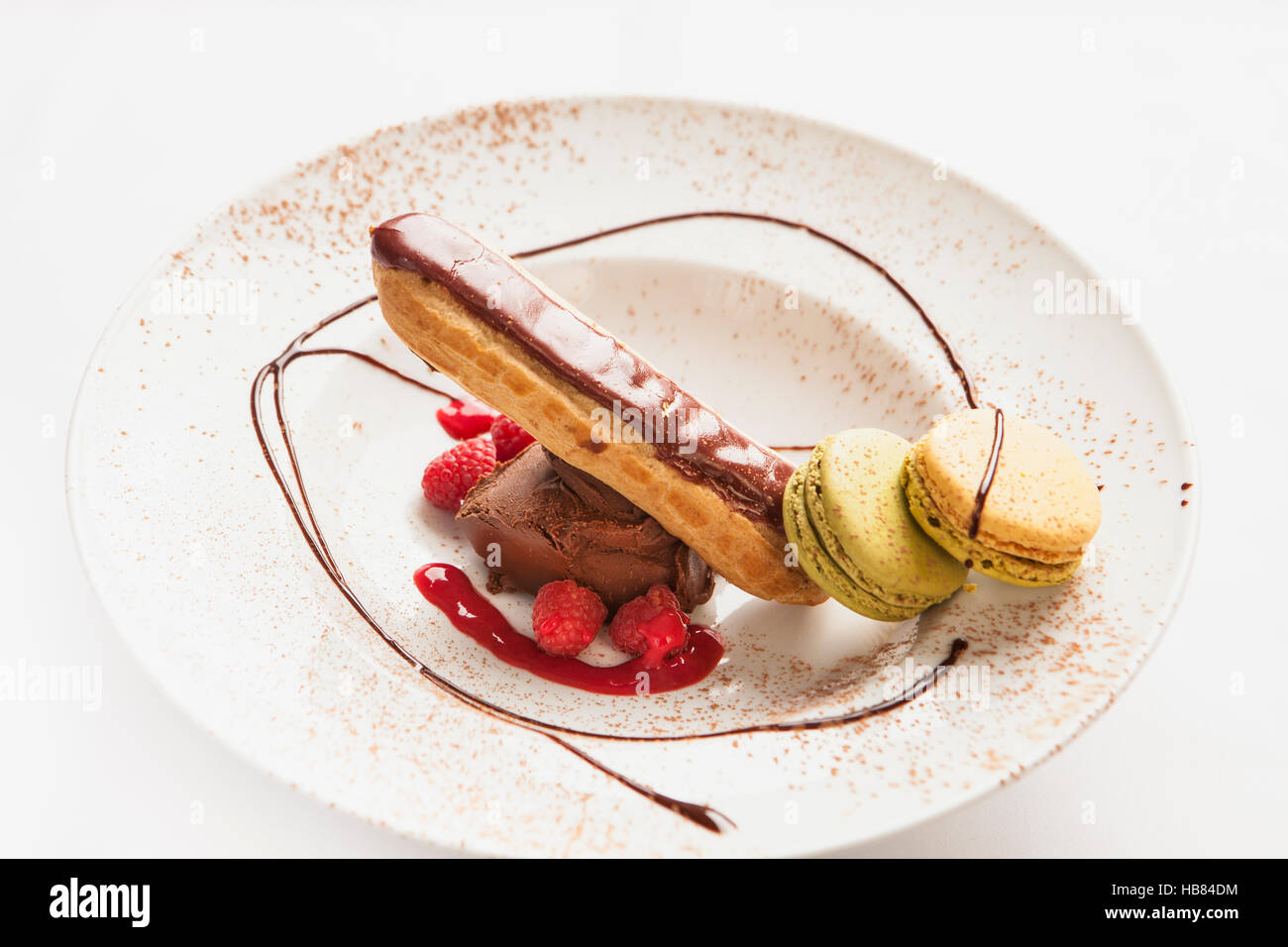 eclair with macaroons, chocolate ice cream and raspberry sauce Stock Photo