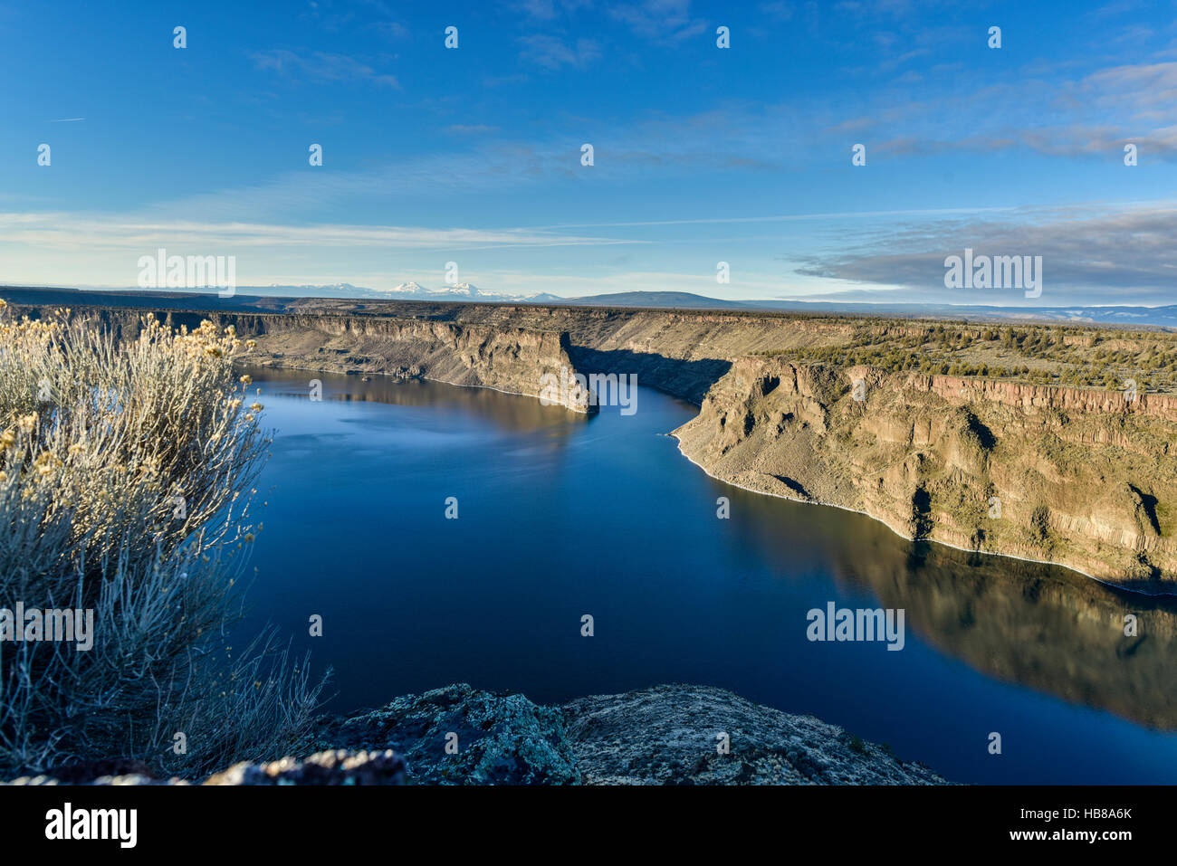 Blue Lake, Cliffs, and Far Off Mountains Stock Photo