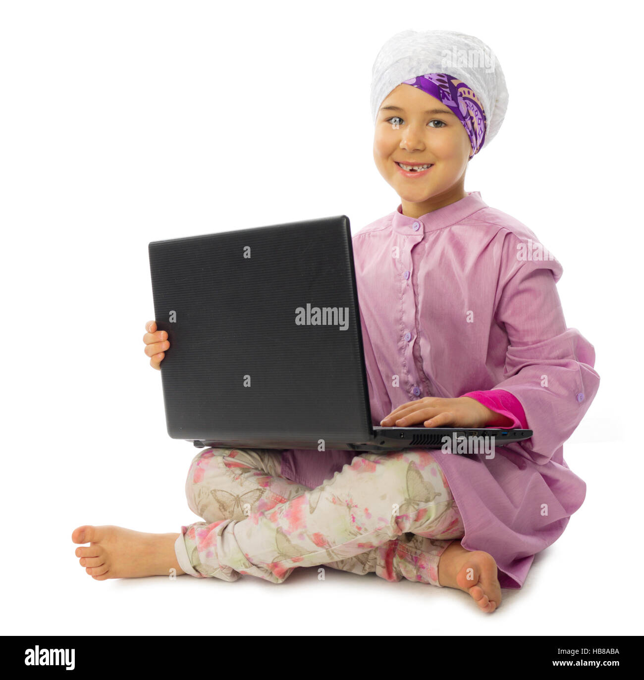 Little muslim girl with laptop isolated Stock Photo