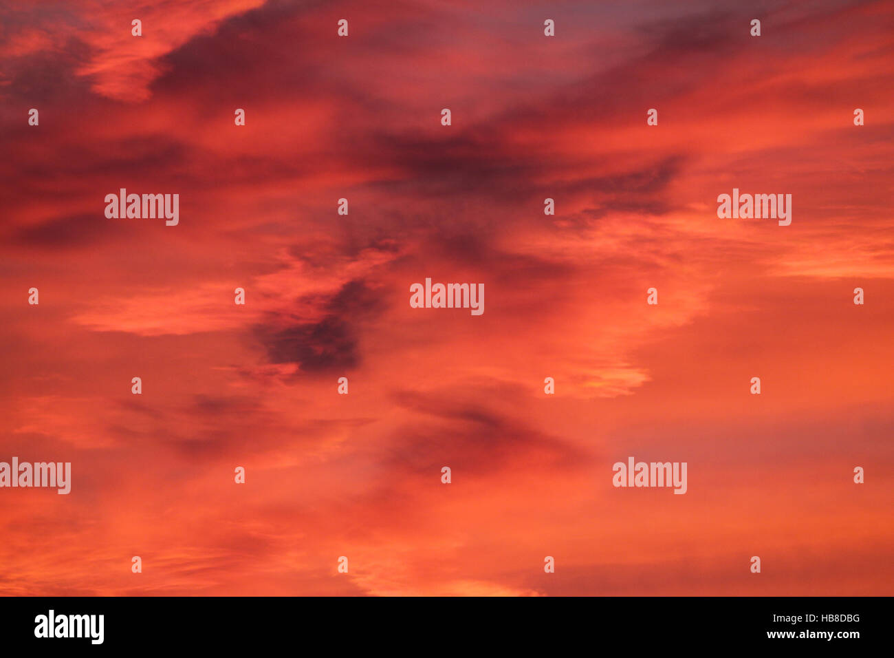 Orange red-stained cloudy sky after sunset, Allgäu, Bavaria, Germany Stock Photo