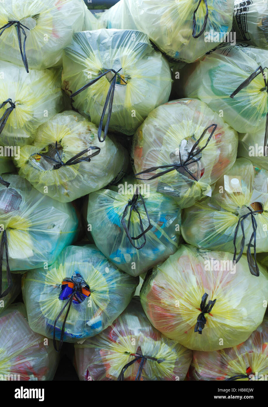 Stacked yellow bags for plastic waste hires stock photography and