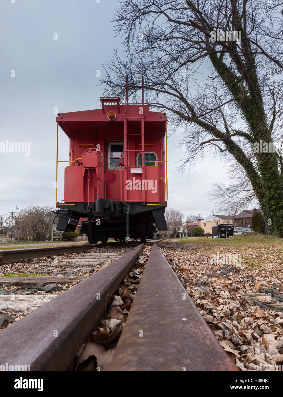 Old red caboose with train track Stock Photo