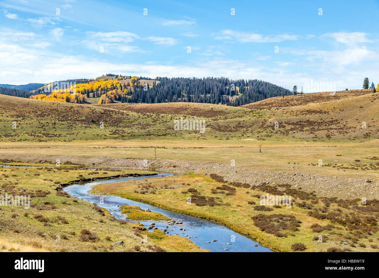 Mountain scenery with streams, valleys, and colorful trees along a train route from Chama, New Mexico to Antonito, Colorado Stock Photo