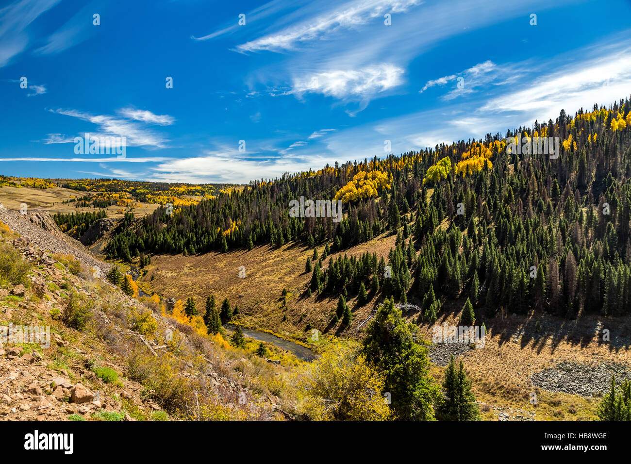 Mountain scenery with streams, valleys, and colorful trees along a train route from Chama, New Mexico to Antonito, Colorado Stock Photo
