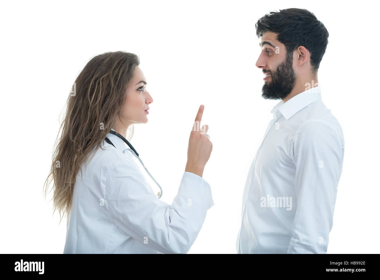 Doctor with ticking clock and Serious Male Patient Stock Photo Alamy
